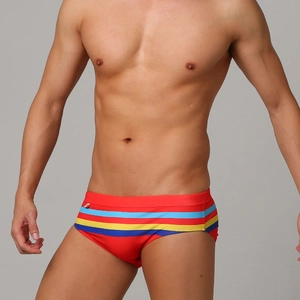 Close-up of red men's swim briefs with colorful side stripes and high-elastic fabric detail