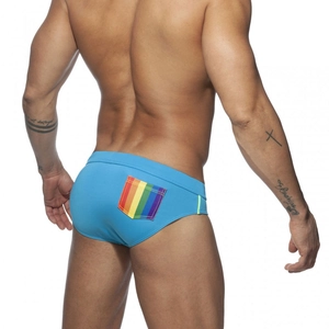 Men's bright blue swim trunks with rainbow stripe pocket detail and snug back view
