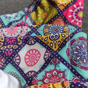Close-up of bohemian mandala print swimwear fabric with reinforced double stitching