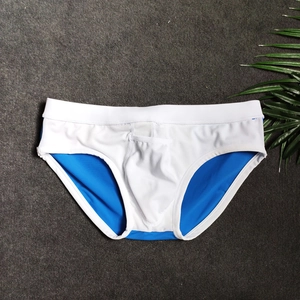 Detailed view of color block men's swim briefs featuring U-convex pouch and elastic waistband