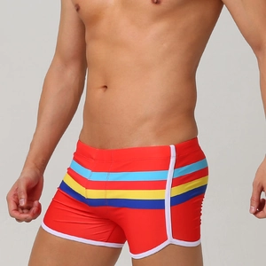 Men's red swimming trunks with colorful striped waistband and white trim details