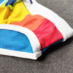 Detailed macro view of colorful patchwork swim briefs with quick-dry fabric and blue drawstring