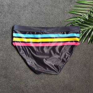 Close-up of men's swim briefs with colorful stripes on a fast-drying elastic fabric