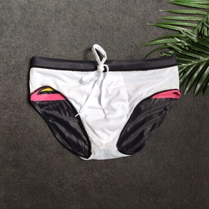 Detail of white striped men's swim briefs with colorful side panels and adjustable drawstring