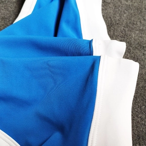 Detailed close-up of high-stretch blue and white nylon fabric for men's swimming trunks
