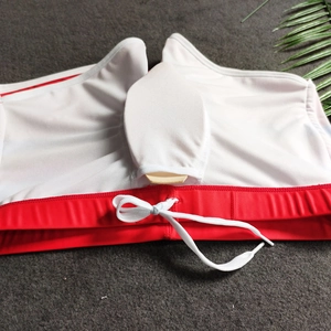 Macro view of men's red swim trunks featuring removable support cup and mesh lining