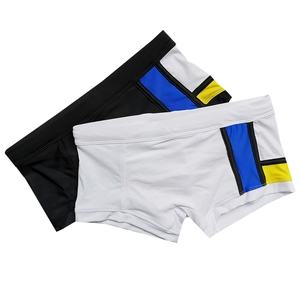 Detail view of mens patchwork swim trunks featuring side color blocks and elastic fabric