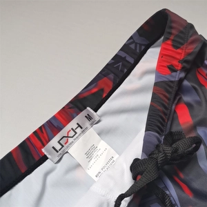 Detail of men's swim trunks waist with drawstring and inner fabric composition label
