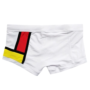 Detail view of quick-dry men's swim trunks with colorful geometric patchwork design