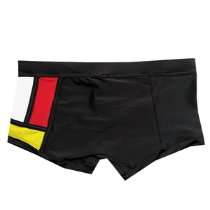 Detail view of men's swim trunks featuring color-block panels and reinforced double stitching