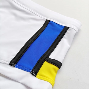Close-up of contrast color panels and flatlock stitching on men's swim trunks