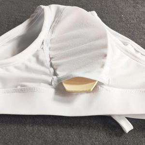 Detail view of the interior pocket and removable padding in the white men's bikini swimwear