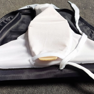 Detail of men's striped swim briefs showing inner pouch with removable sponge padding