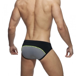 Men's mosaic print swim briefs with black fabric and neon green piping accents