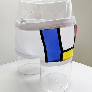 Detail of color block swim trunks with drawstring waist on a male display mannequin