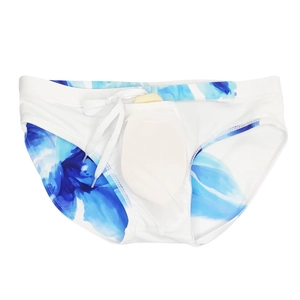 Detailed close-up of blue ink flower print on white swim briefs with drawstring waist