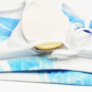 Detail view of swim trunks featuring removable chest pad and watercolor floral print fabric