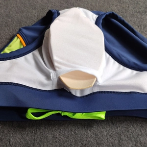 Detail of navy swim briefs with neon green drawstring and removable inner protective pad