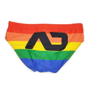 Detail of men's rainbow striped swim briefs featuring black AD logo on the back