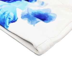 Close-up of blue ink flower pattern on men's white swimwear with reinforced stitching