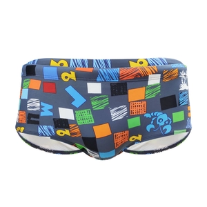 Men's square-cut swim trunks with colorful graffiti art and geometric patterns on dark gray