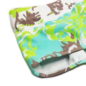 Close-up of men's swimming trunks featuring abstract camouflage print and reinforced seams