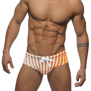 Men's white swim briefs with orange polka dots and functional white drawstring waist