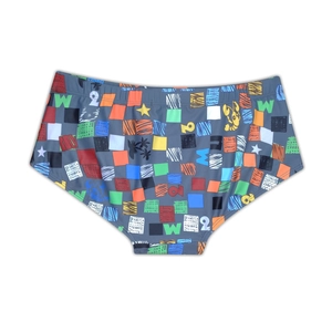Close-up of men's square-cut swim trunks featuring colorful digital prints on dark grey fabric