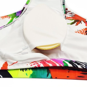 Detail view of colorful palm print swimwear with soft removable padding and white lining