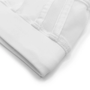 Close-up of white swim trunks featuring elastic band and breathable mesh fabric texture