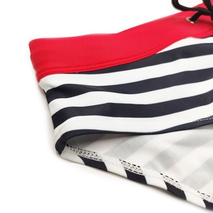 Detail of striped swim briefs showing red waistband and black adjustable drawstring cord