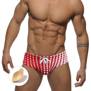 Men's red low-rise swim briefs with white polka dots and adjustable drawstring pouch
