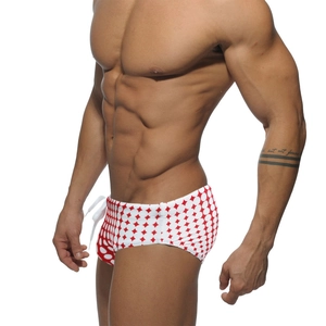 Close-up of men's swimming briefs with red geometric dots and adjustable drawstring