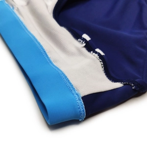 Macro view of tight overlock stitching on navy blue nylon swimwear with mesh lining