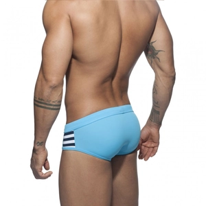 Detail view of men's blue swim briefs with striped side panels and athletic fit design
