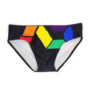 Detail view of men's swimming briefs featuring colorful geometric patterns on black fabric