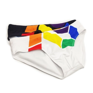 Close-up of men's white swim briefs with colorful geometric prints and elastic fabric