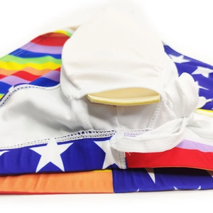 Macro detail of men's swim briefs featuring rainbow stripes and removable sponge cup padding