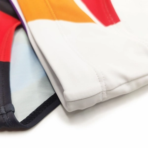 Close-up of high-quality stitching and elastic synthetic fabric on men's striped swimwear