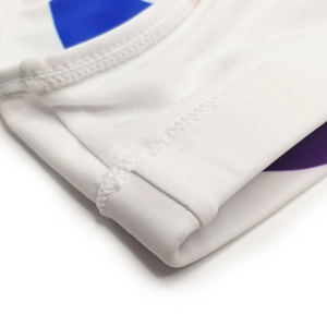 Detail view of double-needle stitching on white elastic swimwear fabric with blue patterns