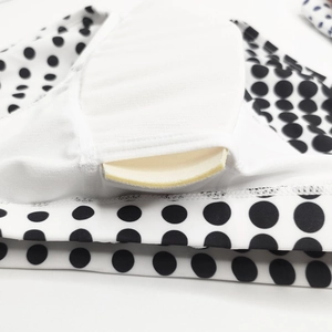 Detail view of the polka dot swimwear featuring an internal slot with a removable cup pad