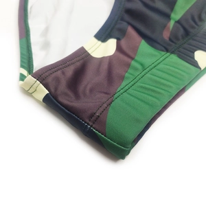 Close-up of camouflage swim briefs showing reinforced stitching and premium elastic fabric
