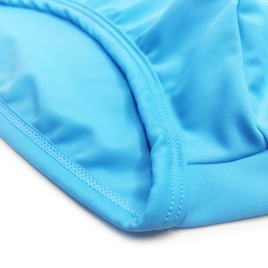 Detail of sky blue swim trunks showing high-elastic fabric and flat double-needle stitching