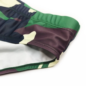 Detail of army green camouflage swim briefs showing elastic waistband and stitching