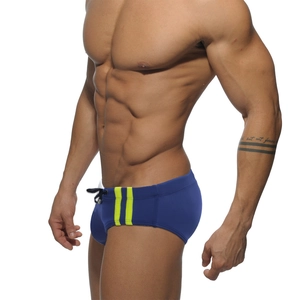 Men's navy blue athletic swim briefs with neon green side stripes and drawstring waist