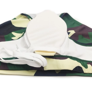 Close-up of men's camouflage swim briefs featuring removable protective pad and mesh lining
