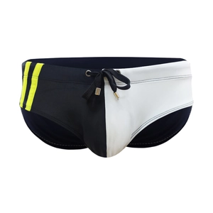 Detailed view of color-block swim trunks with yellow stripes and drawstring waist