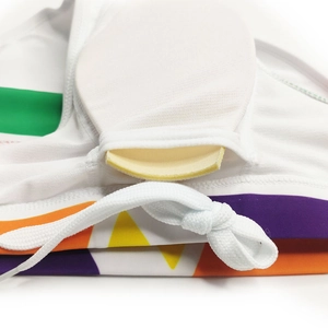 Detail view of swim trunks featuring striped waistband and removable padded cup lining
