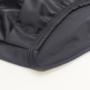 Close-up of black elastic swimwear fabric featuring high-quality double-needle stitching
