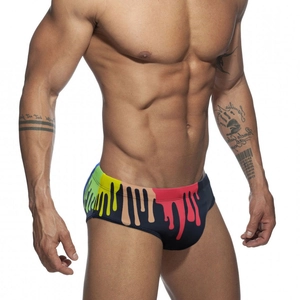 Men's tight swimming briefs featuring vibrant rainbow paint drip print on black nylon